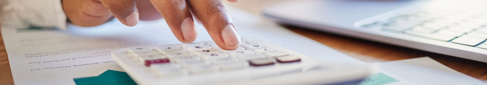 close-up of hands using a calculator