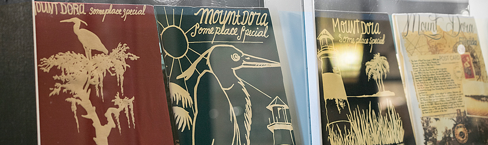 boutique window with artwork calling Mount Dora someplace special